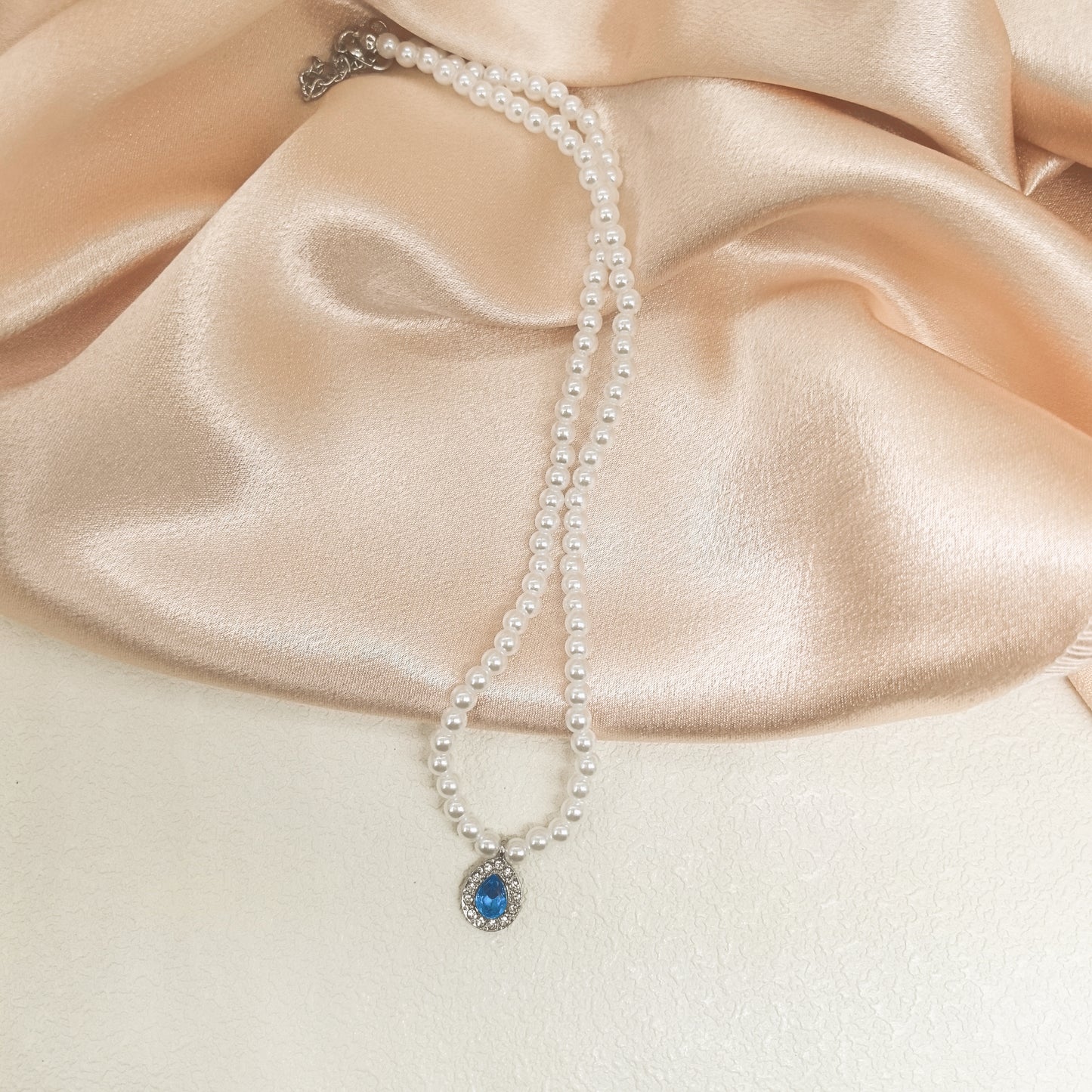 Elegant Pearl Necklace with Blue Crystal Pendant